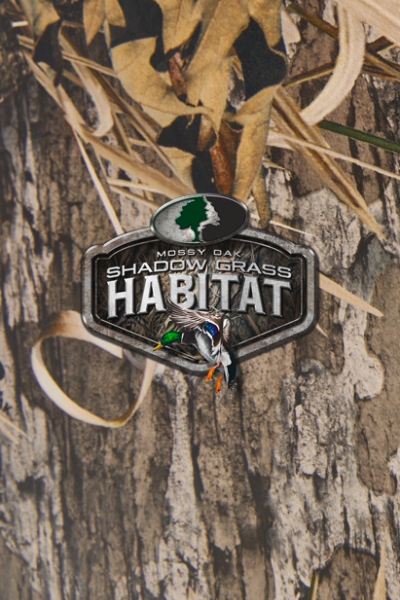 A Mossy Oak Shadow Grass Habitat camouflage print overlaid with the design's logo.
DAM # aaf13784